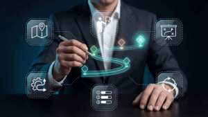 A person in a suit outlines a futuristic holographic workflow with icons for map, user, plan, settings, checklist and circular arrows.